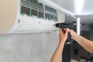male technician repairing air conditioner indoors 2024 02 13 20 59 49 utc 300x199 1