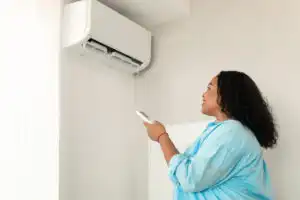 rsz african american woman turning on air conditioner 2023 11 27 05 18 53 utc 300x200 1