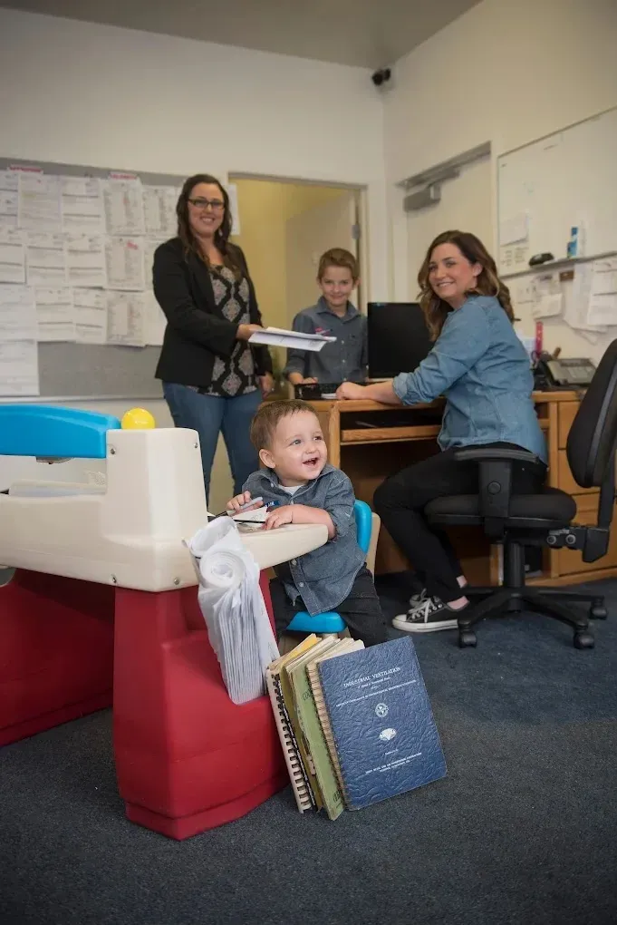 Family enjoying a comfortable indoor environment with visible HVAC unit